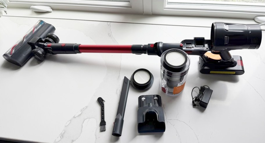 red and gray vaccum with accessories on table