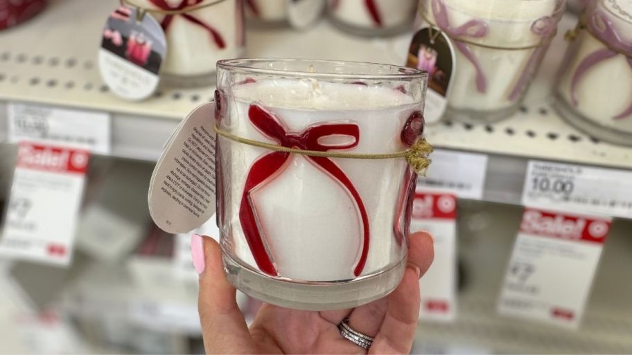 womans hand holding a candle