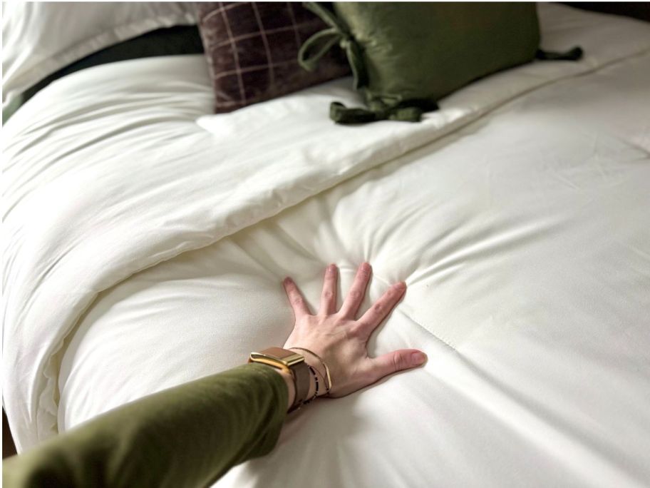Hand pressing on a Litanika comforter