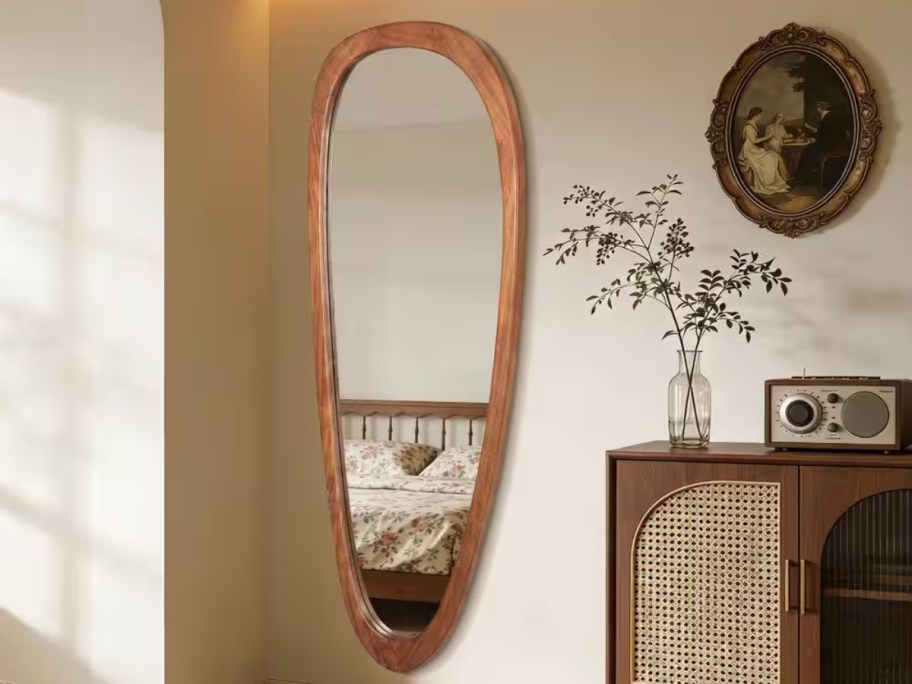 irregular full-size mirror hanging on wall