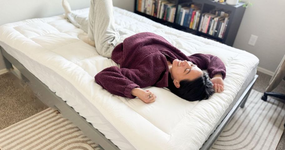 chelsey laying on dual layer mattress topper