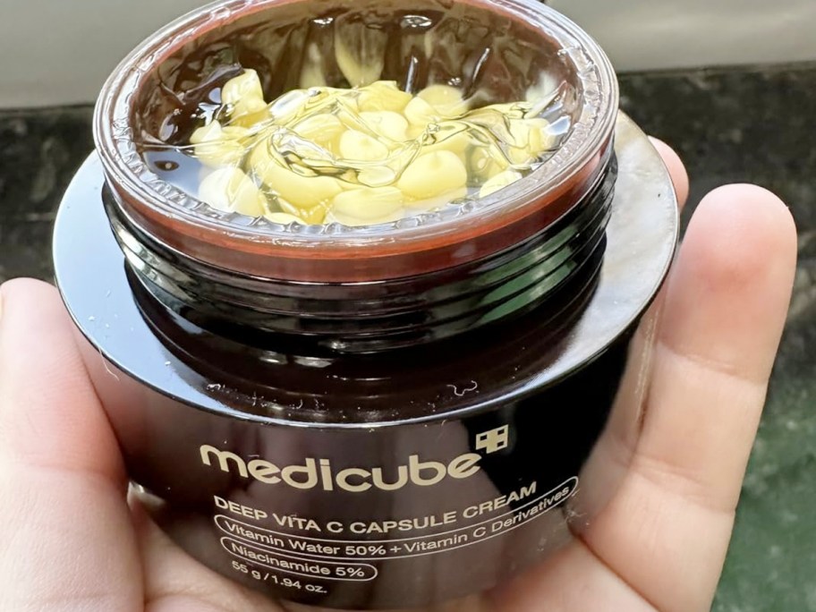 hand holding medicube jar 
