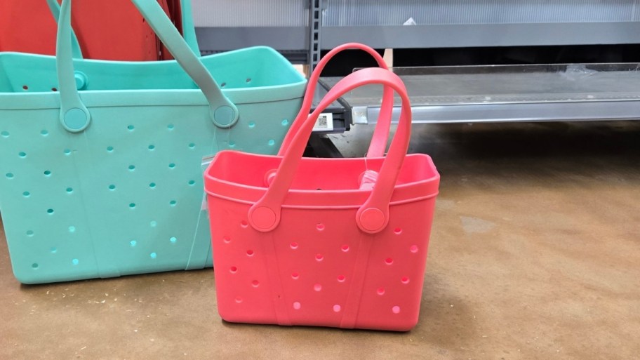 small pink tote next to large green tote