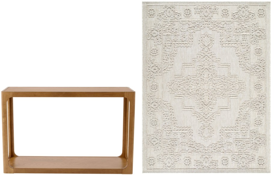 A minimalistic setup featuring a rectangular wooden table and a white rug with a textured, intricate geometric pattern.