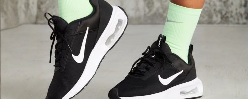 women's feet and ankles wearing Nike Air Max shoes and green Nike socks