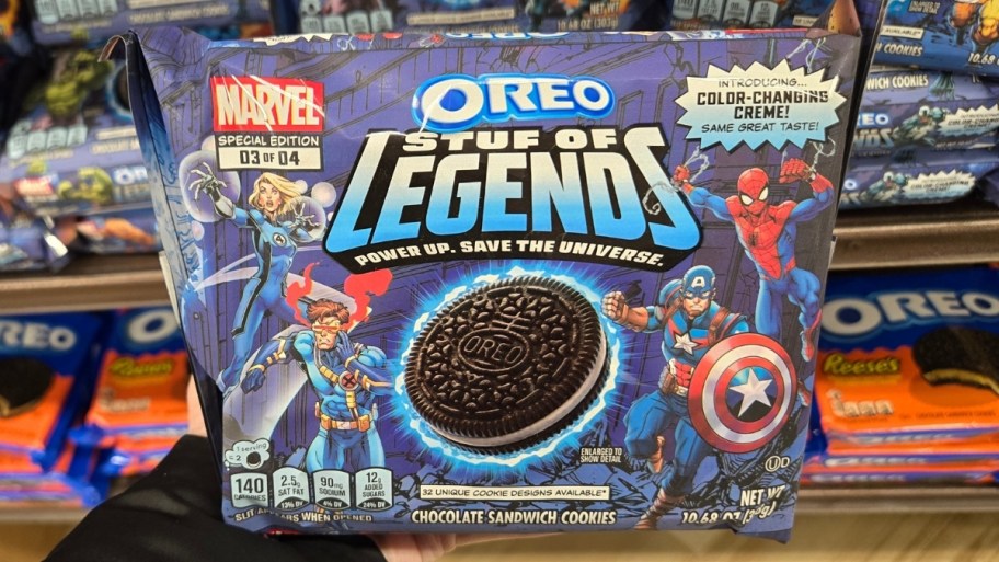 womans hand holding a bag of marvel oreos