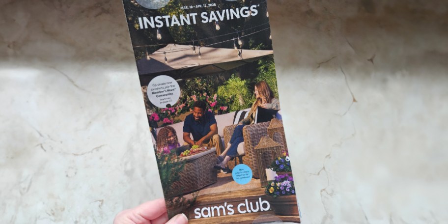 hand holding instant savings flyer