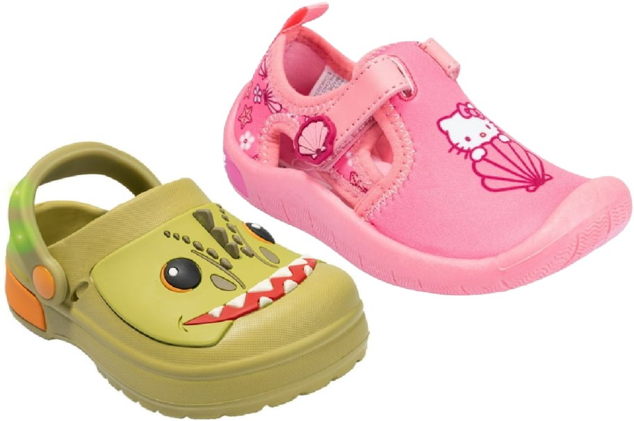 Two children's shoes: a green dinosaur clog and a pink Hello Kitty water shoe.