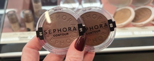 a hand holding 2 sephora contour powder compacts