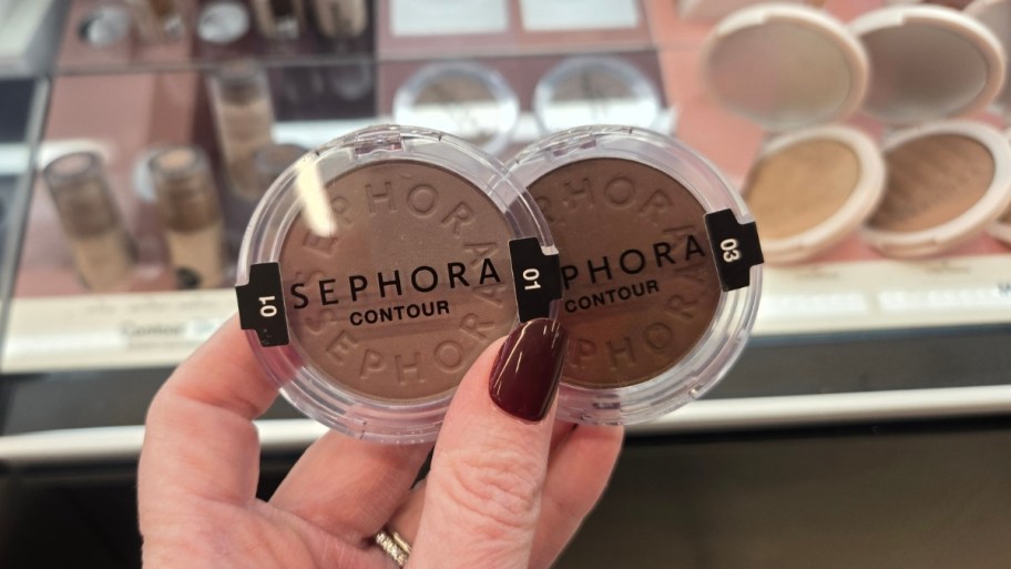 a hand holding 2 sephora contour powder compacts