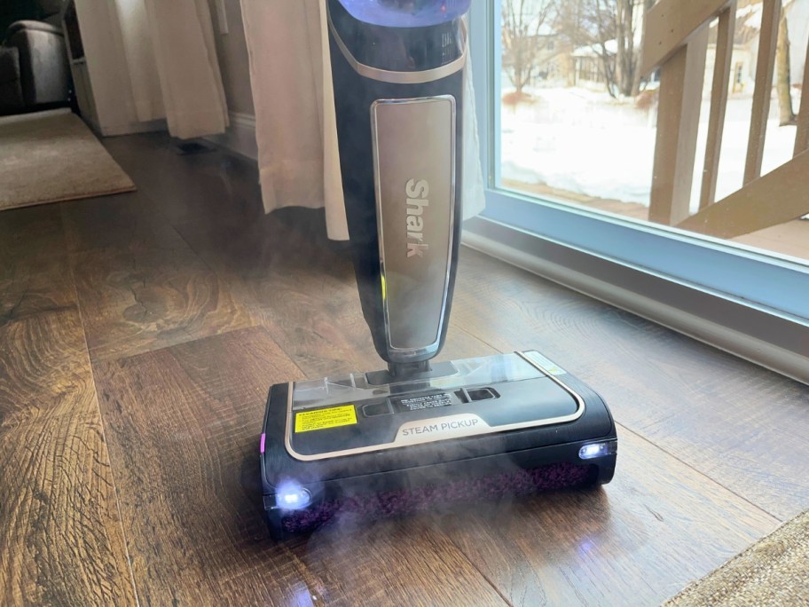 a Shark Vacuum mop with steam coming out if it being used to clean a floor