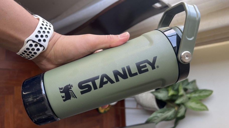 a persons hand holding a stanley vitalize shaker bottle