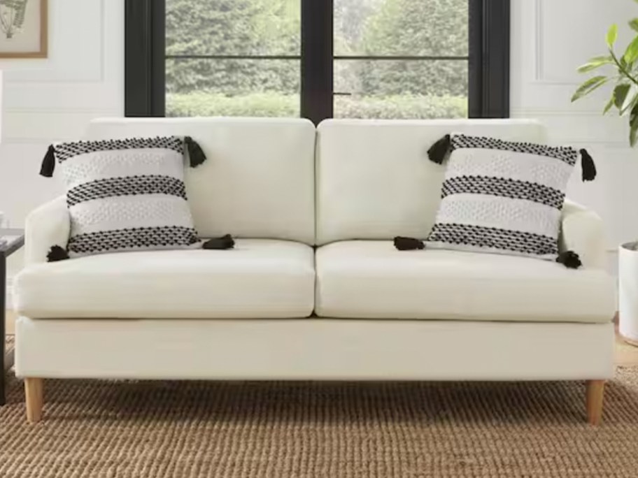 white sofa with blue striped pillows