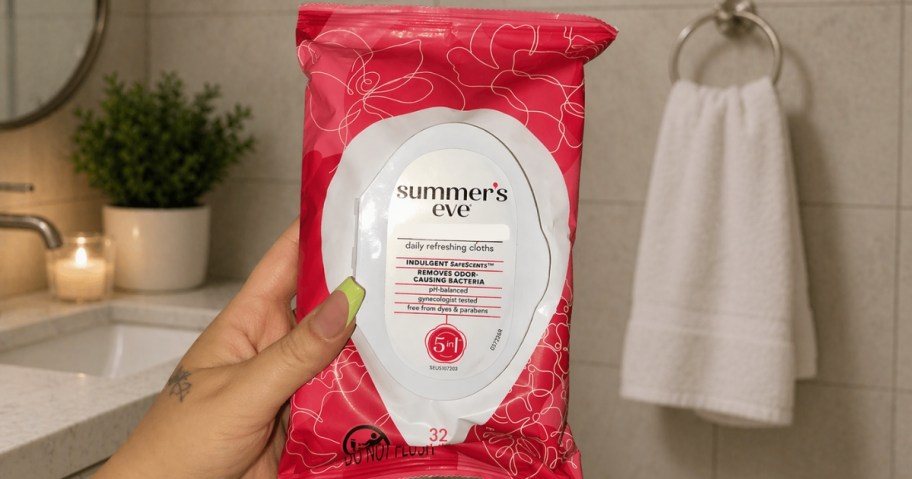 hand holding a pack of Summer's Eve wipes