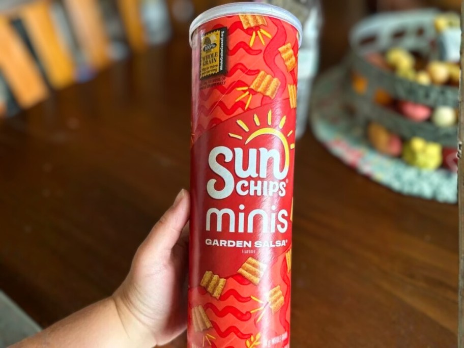 hand holding a canister of SunChips minis
