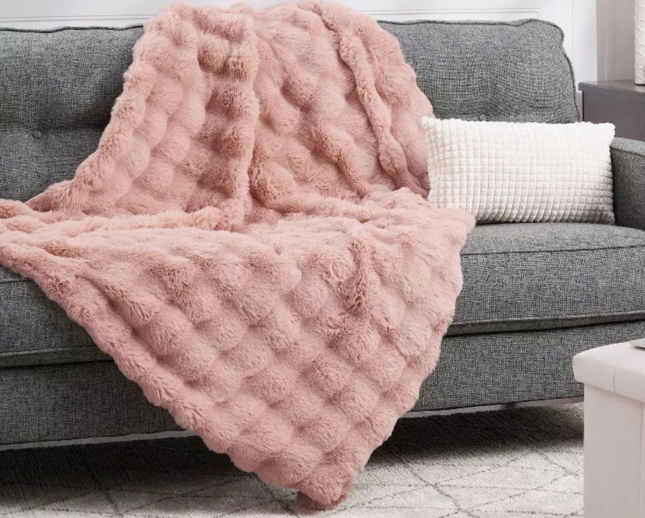 pink bubble blanket on gray couch