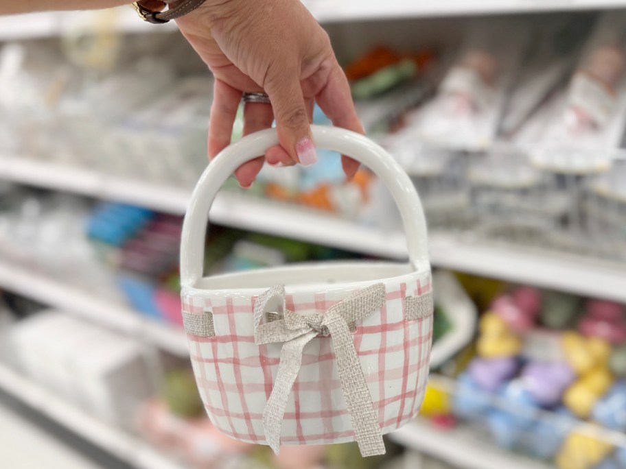 womans hand holding a ceramic basket