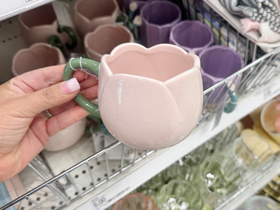 womans hand holding a coffee mug
