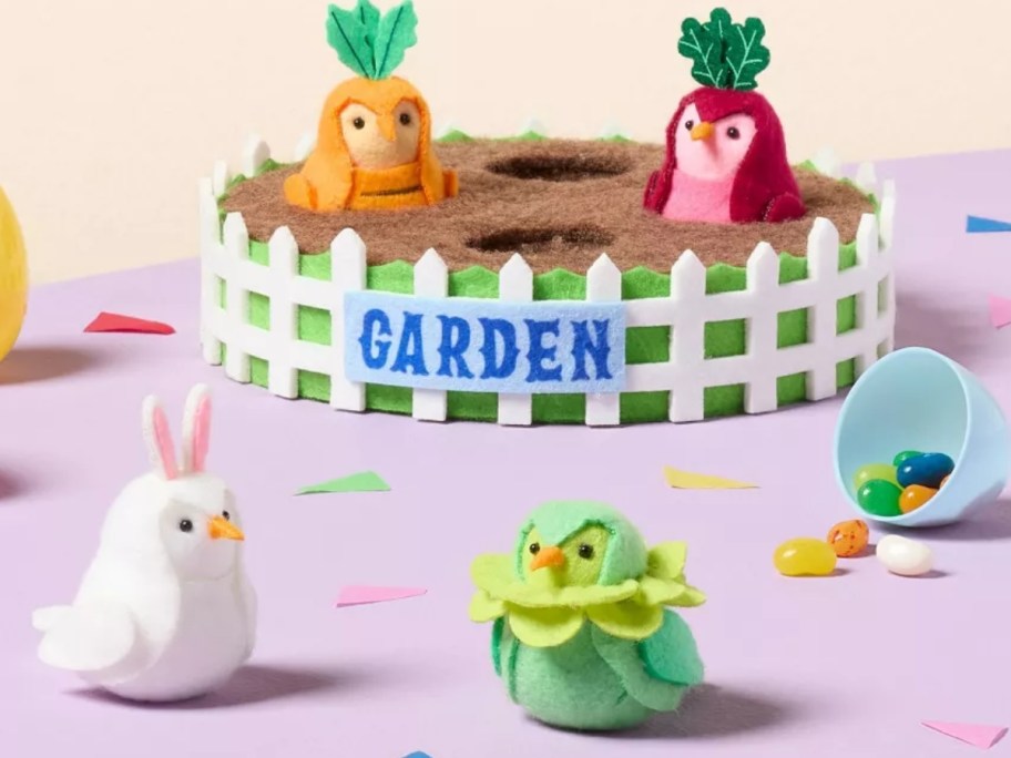 a decorative Easter garden with birds dressed as vegetables