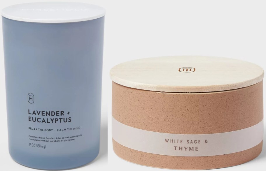 Two candles are shown. The left is a tall, blue "Lavender + Eucalyptus" candle, and the right is a round, tan "White Sage & Thyme" candle with a wooden lid.