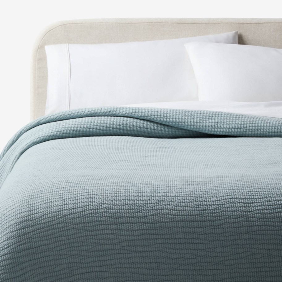 a coverlet on a bed