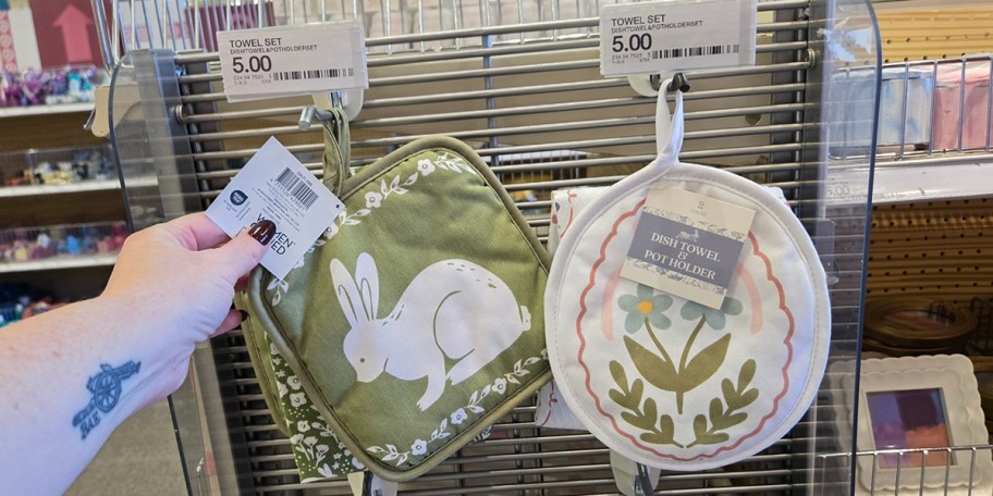 green bunny and white floral dish pot holders hanging in store 