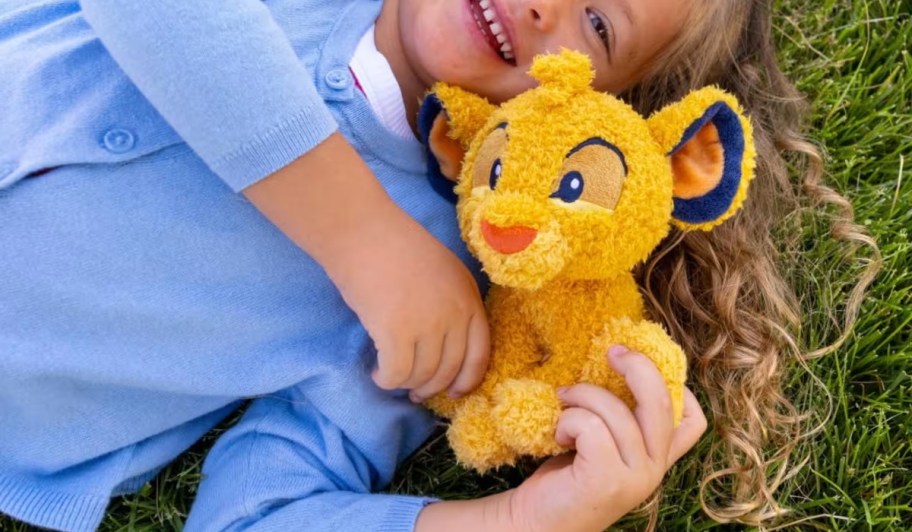 child holding Simba character Tonies