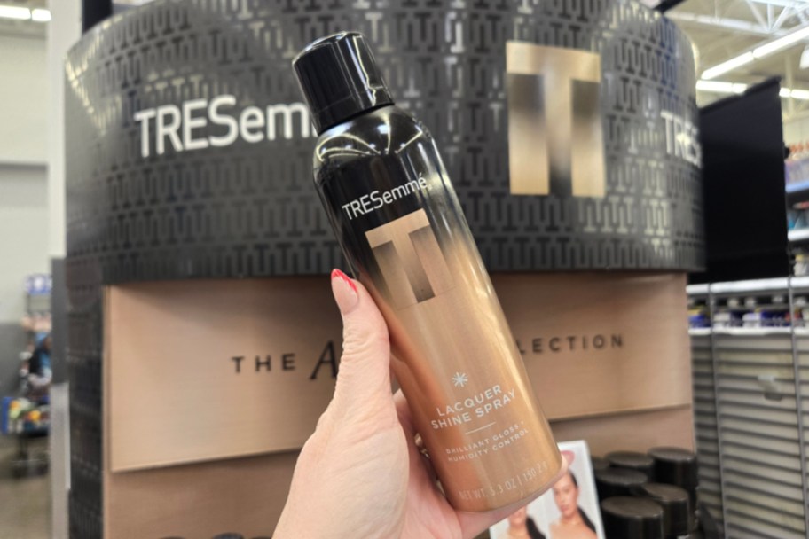 hand holding shine spray bottle in store