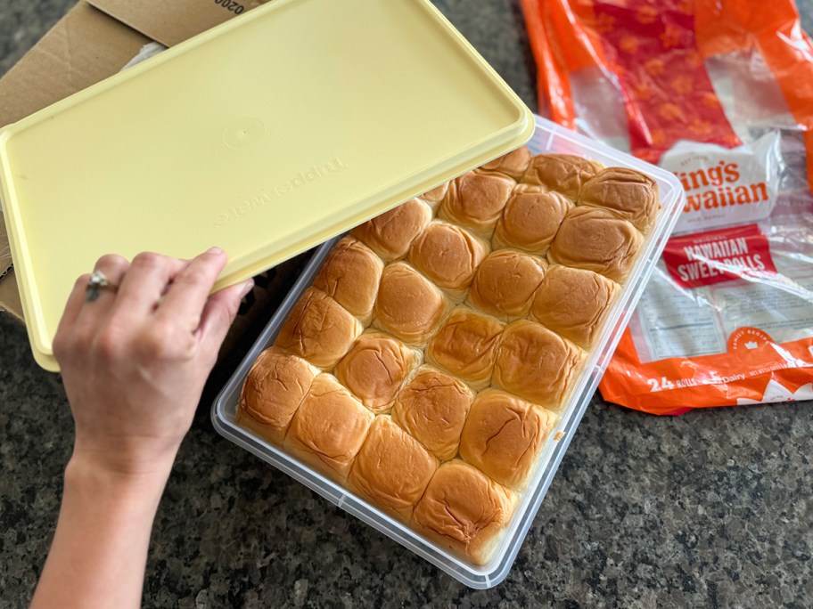 I'm reaching for a storage container full of Hawaiian rolls. 