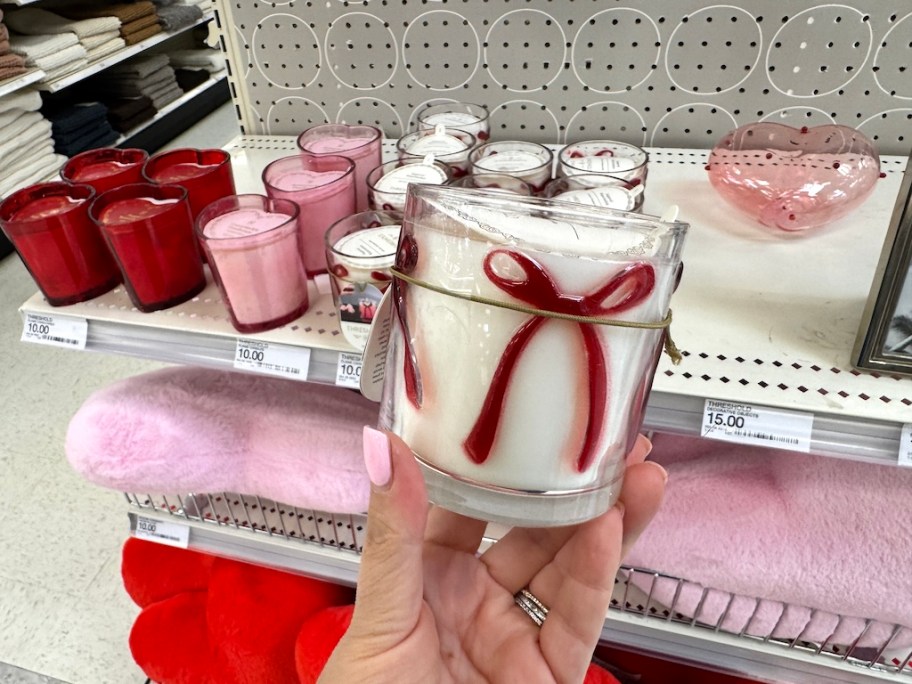 woman holding target bow candle