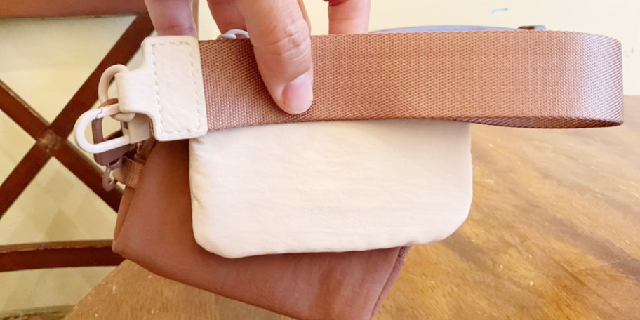 hand holding brown and white wristlet