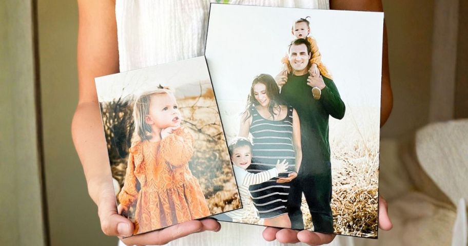 woman holding two walgreens wood photo panels