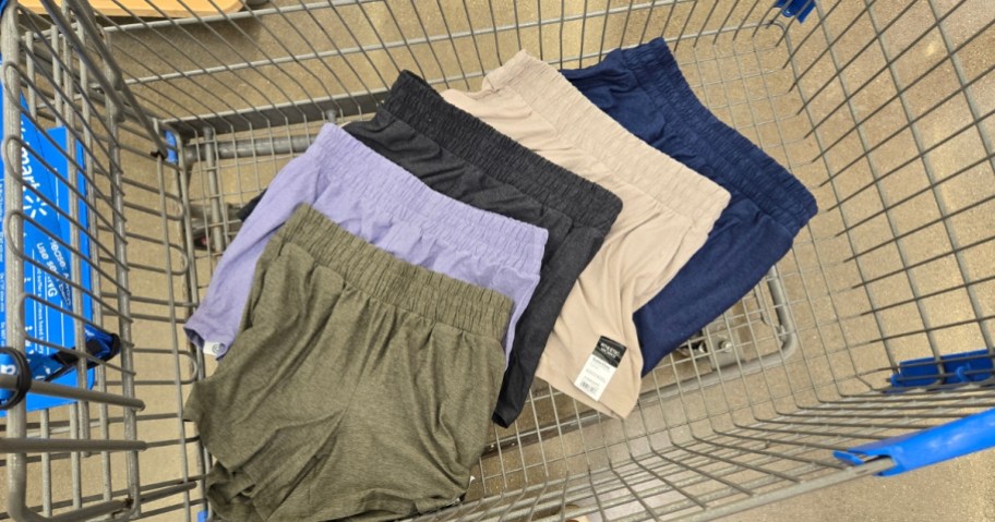 five different colors of women's cotton shorts in a Walmart cart