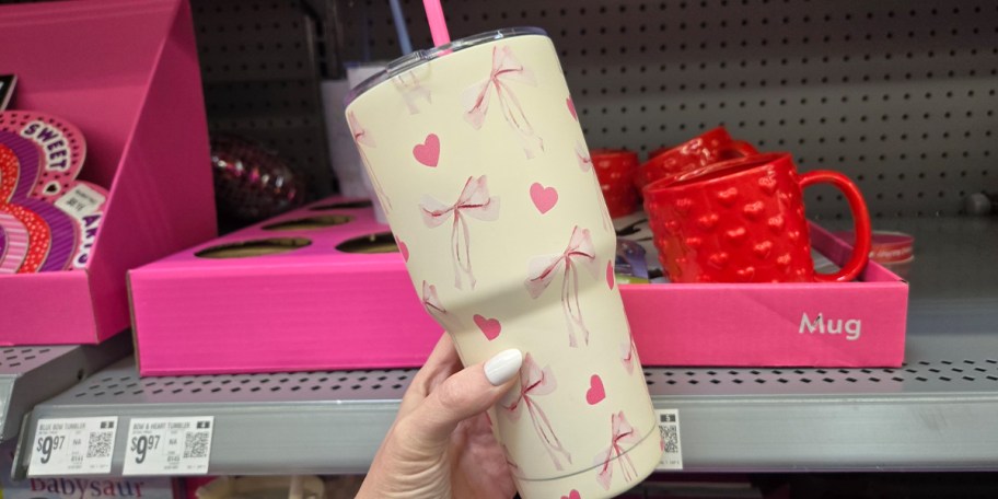hand holding pink bow tumbler