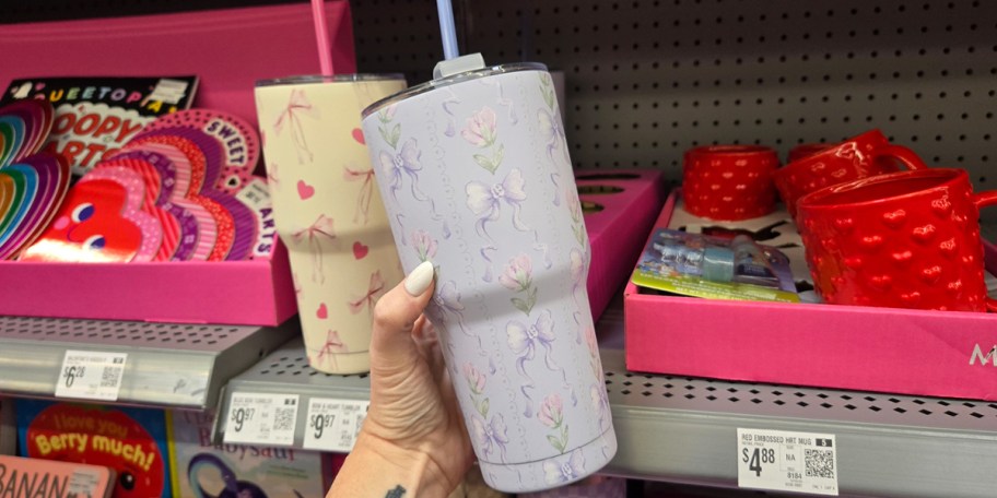 hand holding floral blue tumbler