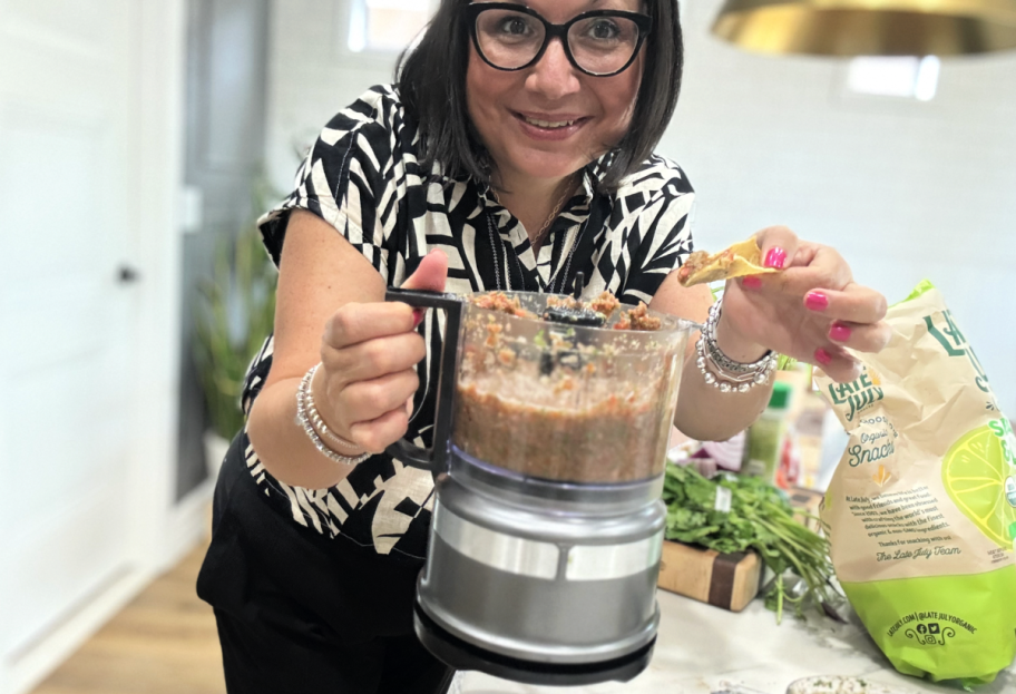 woman making homemade salsa in a food chopper
