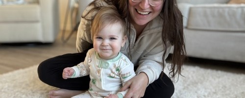 a woman with a baby wearing burts bees pajamas