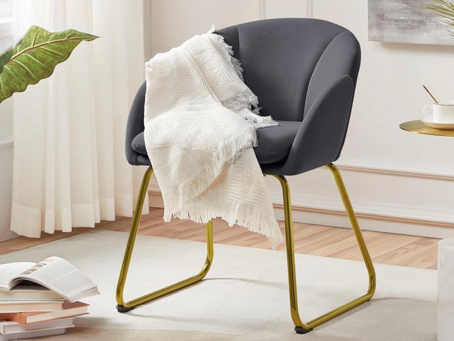 gray and gold accent chair with white blanket 