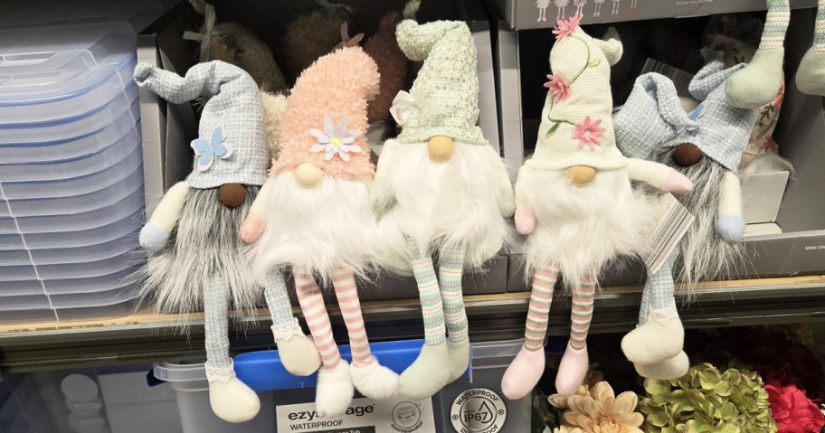 mini gnomes sitting in a row on a store shelf