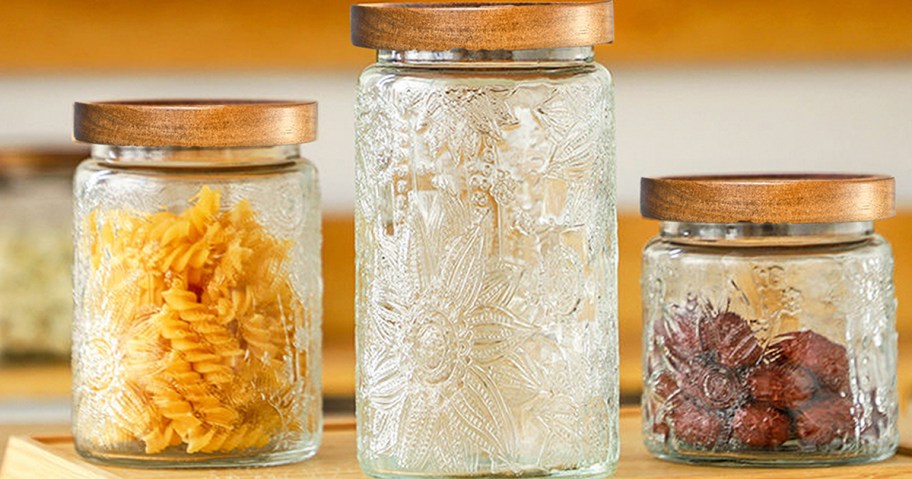 three glass jars with floral embossing on the sides