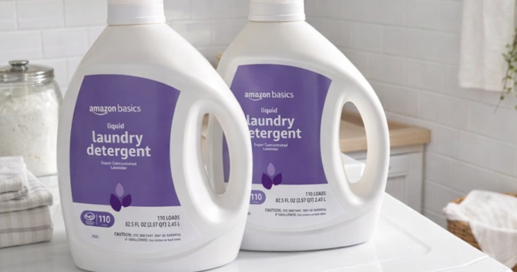 Two bottles of Amazon basics liquid laundry detergent on top of washing machine