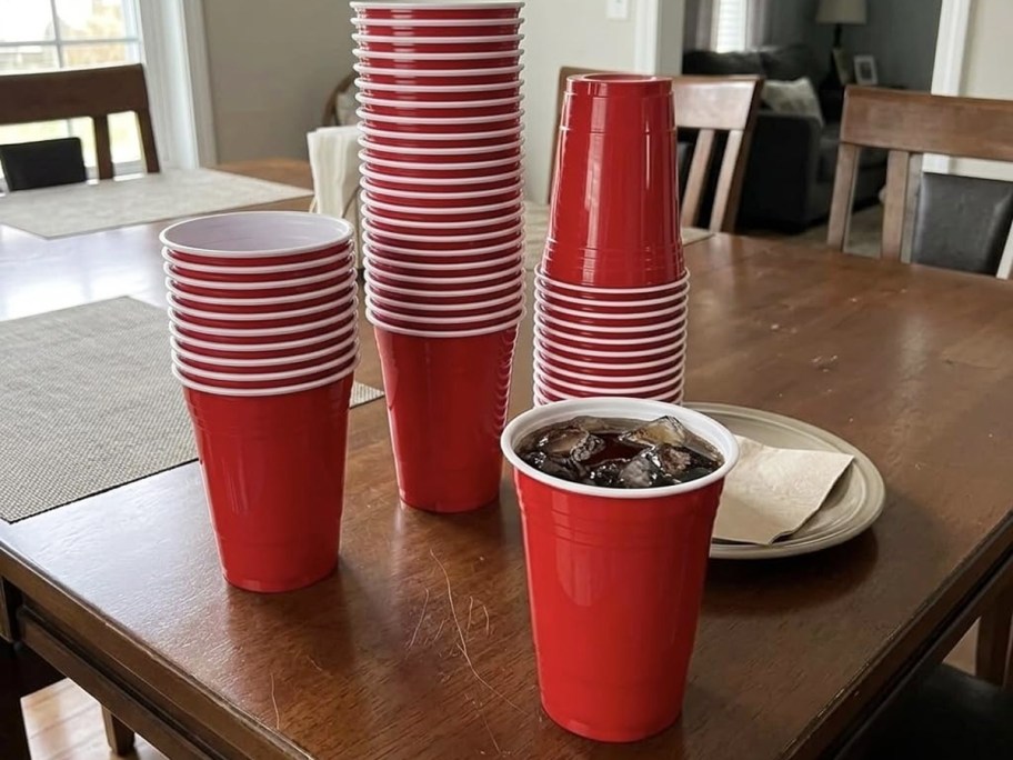 red plastic party cups on a wood table