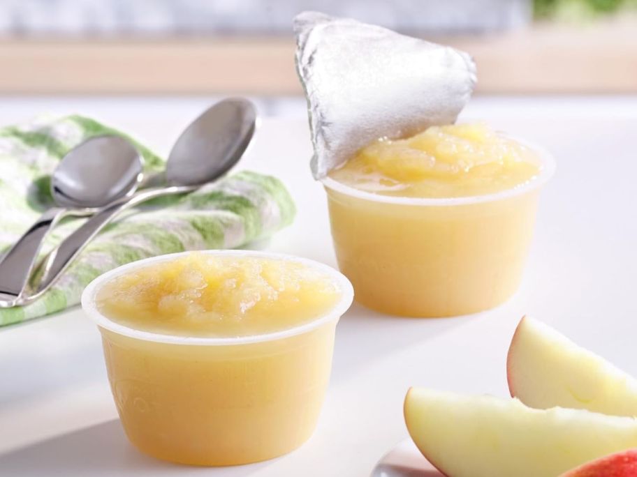 two applesauce cups withe the foil peeled off