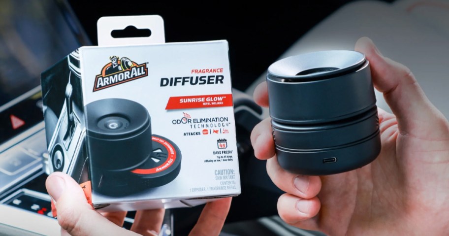 hands holding black Armor All Fragrance Diffuser and its box