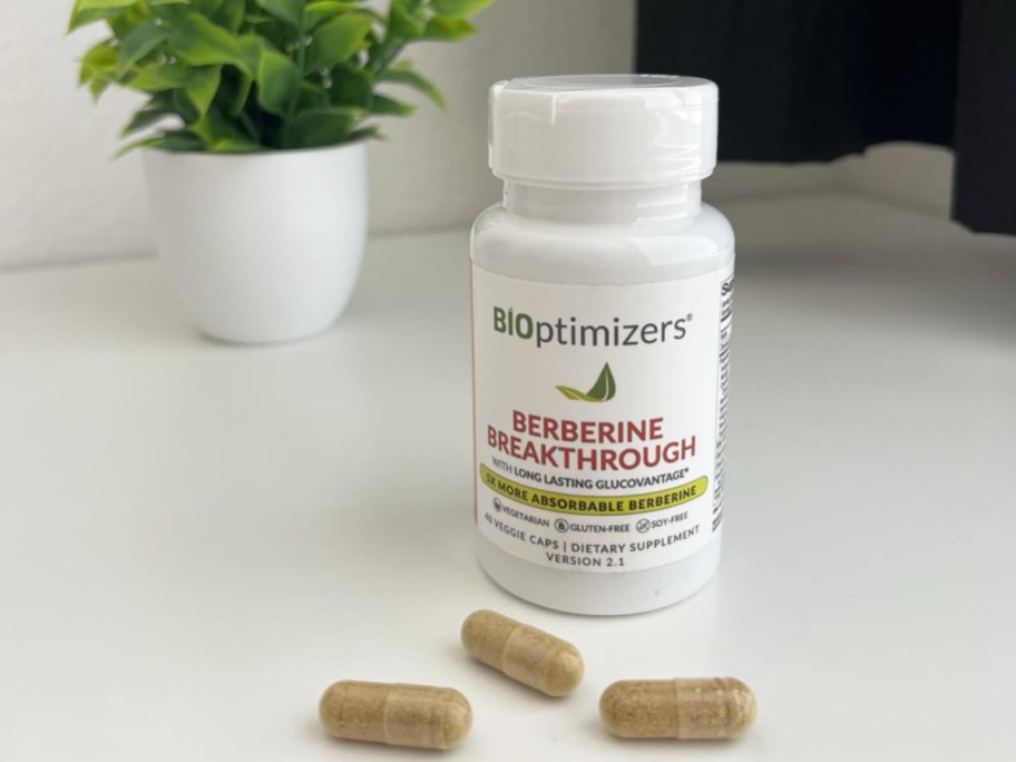 3 pills on table in front of BIOptimizers Berberine Breakthrough Supplement bottle