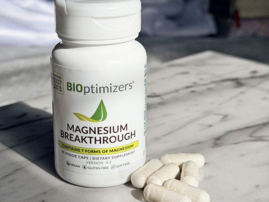 white pills on table in front of BIOptimizers Magnesium Breakthrough Supplement