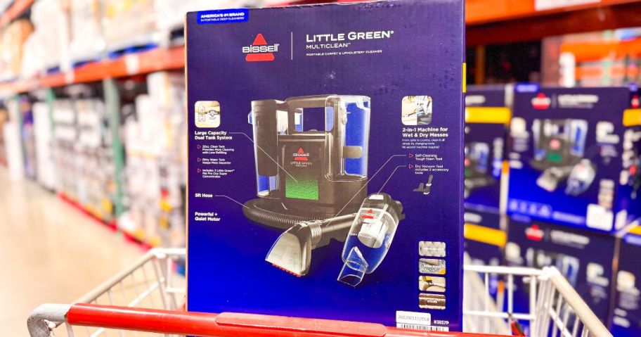 A costco shopping cart with a BISSELL Little Green MultiClean Wet and Dry Portable Carpet and Upholstery Cleaner in it