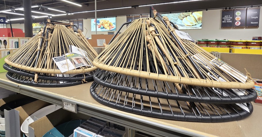 oval shaped string patio chairs stacked on store shelf