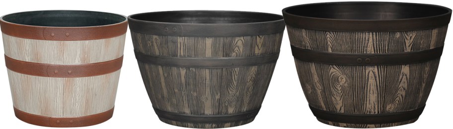 three whiskey barrel planters in a row