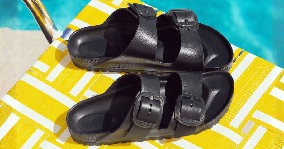 Birkenstock Big Buckle Two-Strap Slide Sandals on towel by pool